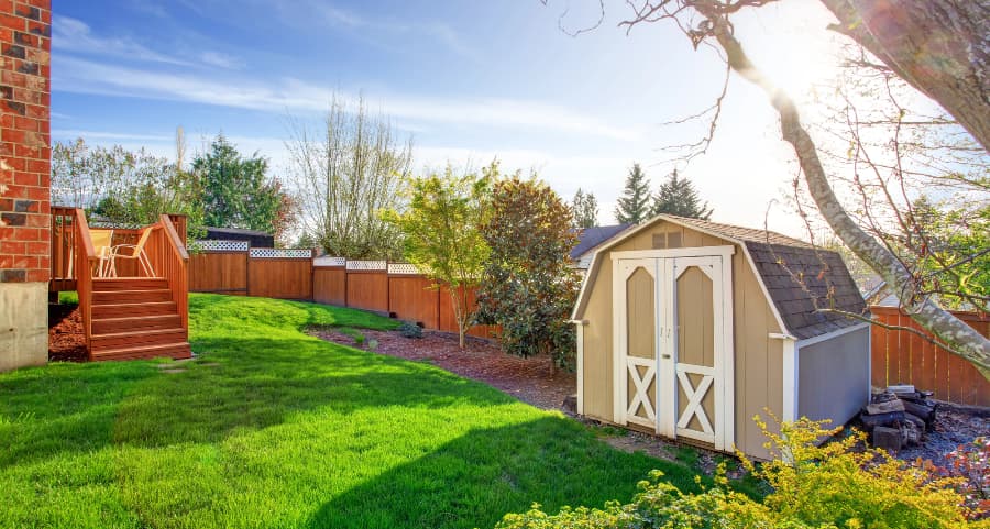 Fenced backyard with storage shed in Lincoln